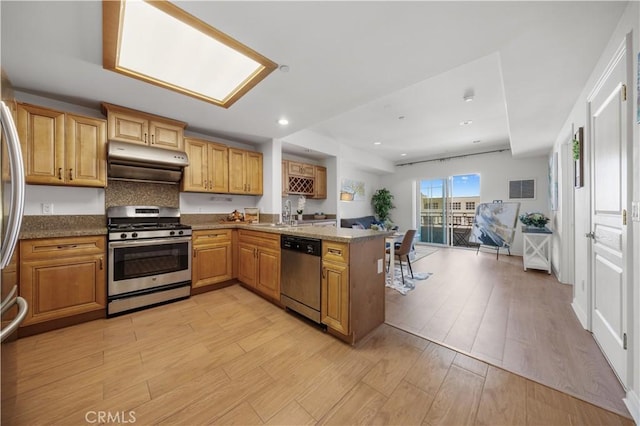 11 S 3rd St Unit 510, Alhambra, CA 91801 - kitchen featuring stainless steel appliances, under cabinet range hood, a peninsula, light wood-style floors, and recessed lighting