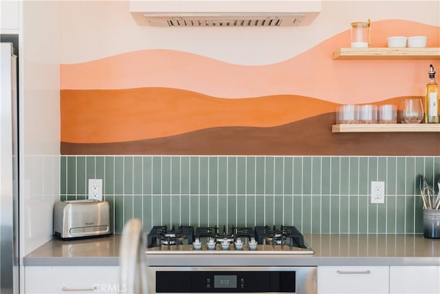 2600 Sunny Vista Rd, Joshua Tree, CA 92252 - kitchen featuring backsplash, stainless steel gas stovetop, wall oven, and white cabinets