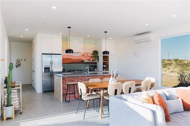 2600 Sunny Vista Rd, Joshua Tree, CA 92252 - living area with a wall mounted air conditioner, concrete flooring, and recessed lighting