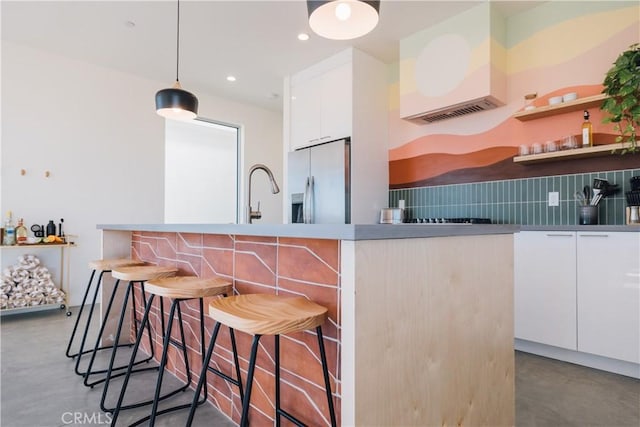 2600 Sunny Vista Rd, Joshua Tree, CA 92252 - kitchen featuring stainless steel fridge, modern cabinets, concrete floors, white cabinetry, and backsplash