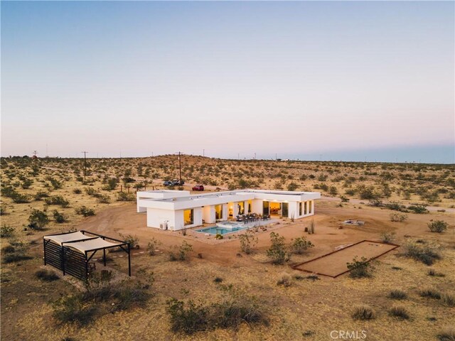 2600 Sunny Vista Rd, Joshua Tree, CA 92252 - back of property at dusk featuring a desert view, a view of rural / pastoral area, and a patio area