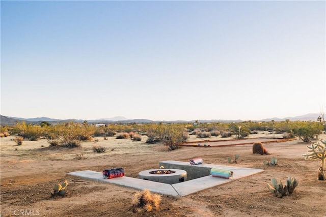 2600 Sunny Vista Rd, Joshua Tree, CA 92252 - view of yard featuring a mountain view, a fire pit, a rural view, and a desert view