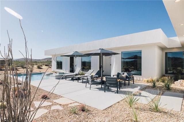2600 Sunny Vista Rd, Joshua Tree, CA 92252 - view of swimming pool featuring a patio area, outdoor lounge area, a mountain view, and a pool with connected hot tub