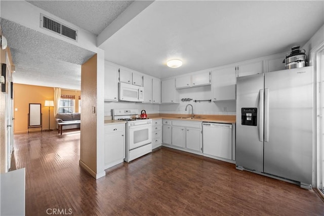 5640 Riverside Dr Unit 119, Chino, CA 91710 - kitchen with white appliances, a sink, dark wood-style flooring, light countertops, and white cabinets
