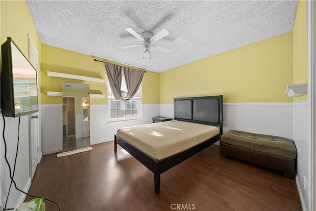 5640 Riverside Dr Unit 119, Chino, CA 91710 - bedroom featuring wood finished floors, a textured ceiling, ceiling fan, and a wainscoted wall