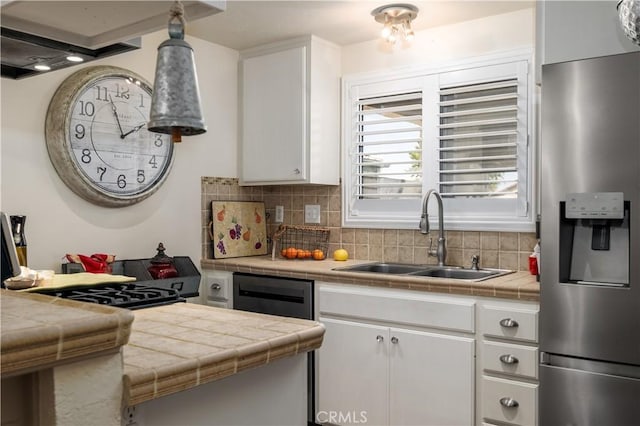 26629 Calle Gregorio, Menifee, CA 92585 - kitchen featuring stainless steel refrigerator with ice dispenser, a sink, tile counters, and white cabinets