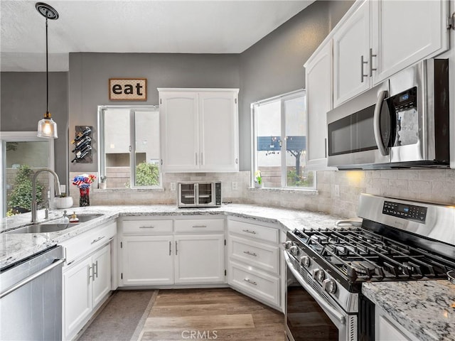 13290DR Country Club Dr, Victorville, CA 92395 - kitchen with appliances with stainless steel finishes, a sink, white cabinetry, and tasteful backsplash