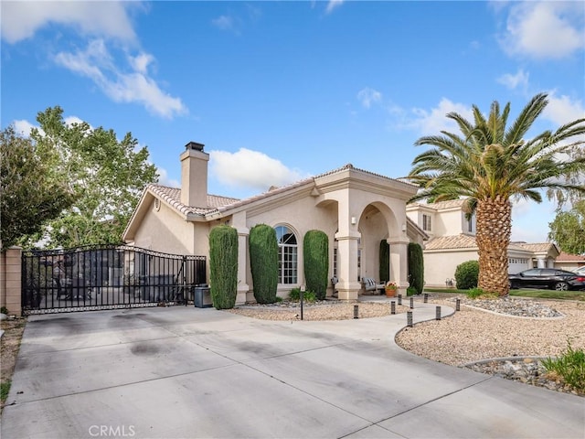 13290DR Country Club Dr, Victorville, CA 92395 - mediterranean / spanish home with stucco siding, driveway, a chimney, and a tiled roof