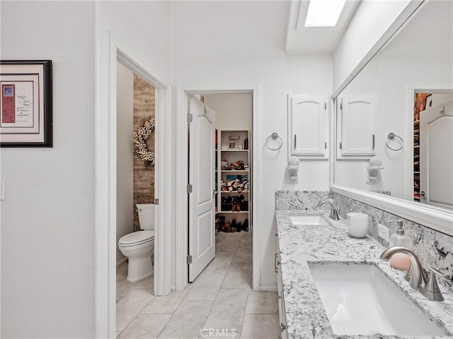 13290DR Country Club Dr, Victorville, CA 92395 - bathroom with double vanity, toilet, tile patterned flooring, and a spacious closet