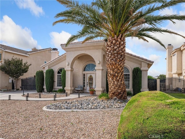 13290DR Country Club Dr, Victorville, CA 92395 - mediterranean / spanish house with a gate, stucco siding, and driveway