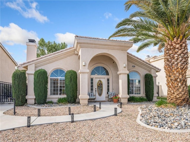 13290DR Country Club Dr, Victorville, CA 92395 - property entrance featuring stucco siding and a chimney