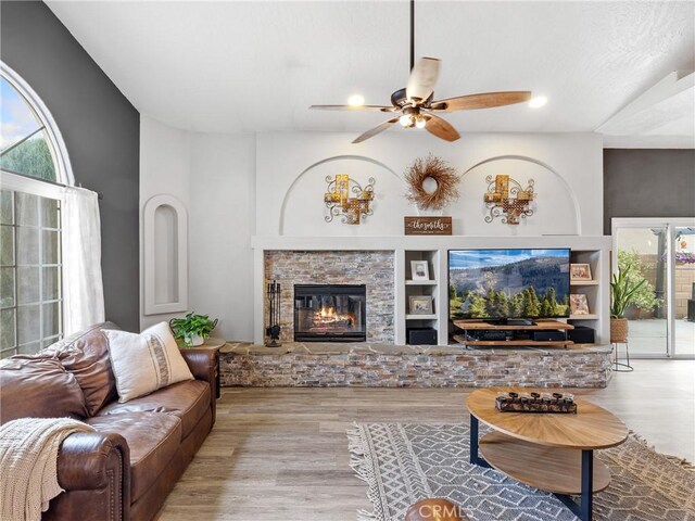 13290DR Country Club Dr, Victorville, CA 92395 - living area with ceiling fan, wood finished floors, plenty of natural light, and a fireplace