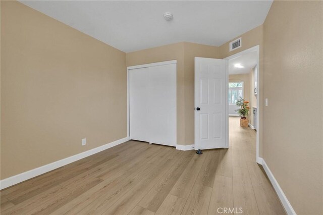 21020 Bryan Cir, Walnut, CA 91789 - unfurnished bedroom with light wood-style floors, baseboards, and a closet
