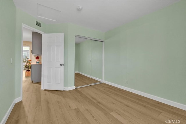 21020 Bryan Cir, Walnut, CA 91789 - unfurnished bedroom with light wood-style flooring, baseboards, and attic access