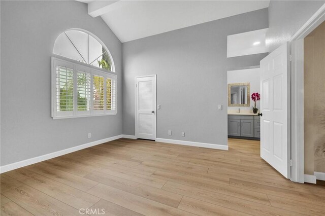 21020 Bryan Cir, Walnut, CA 91789 - unfurnished bedroom featuring beam ceiling, high vaulted ceiling, baseboards, light wood-style floors, and ensuite bath