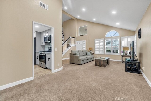 21020 Bryan Cir, Walnut, CA 91789 - living area with light carpet, baseboards, stairway, high vaulted ceiling, and recessed lighting