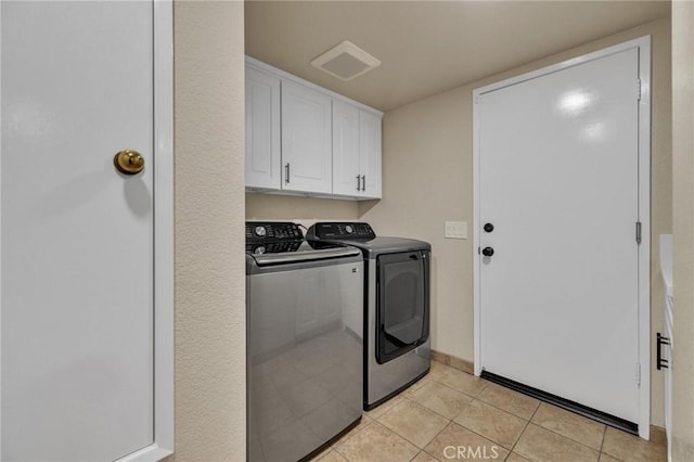 21020 Bryan Cir, Walnut, CA 91789 - laundry room featuring washer and clothes dryer, cabinet space, and light tile patterned flooring