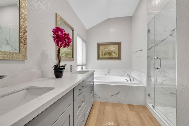21020 Bryan Cir, Walnut, CA 91789 - bathroom with wood finished floors, a garden tub, lofted ceiling, a marble finish shower, and double vanity
