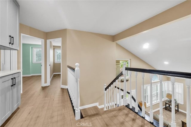 21020 Bryan Cir, Walnut, CA 91789 - hall featuring an upstairs landing, baseboards, plenty of natural light, light wood-style floors, and vaulted ceiling