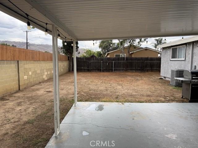 3400 Glasgow Cir, Riverside, CA 92503 - fenced backyard with a patio, central AC unit, and a grill