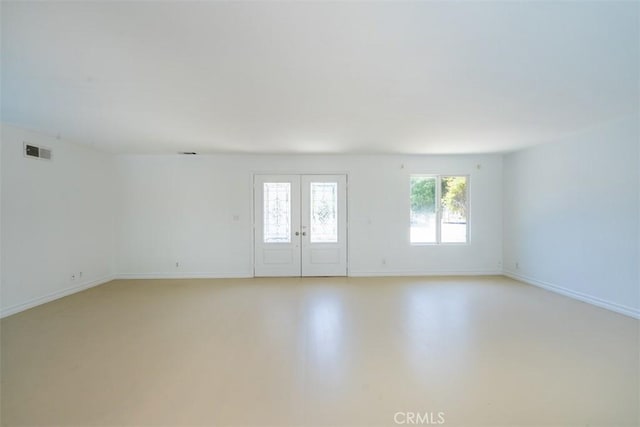 23125 Covello St, West Hills, CA 91307 - spare room with baseboards, french doors, and concrete flooring