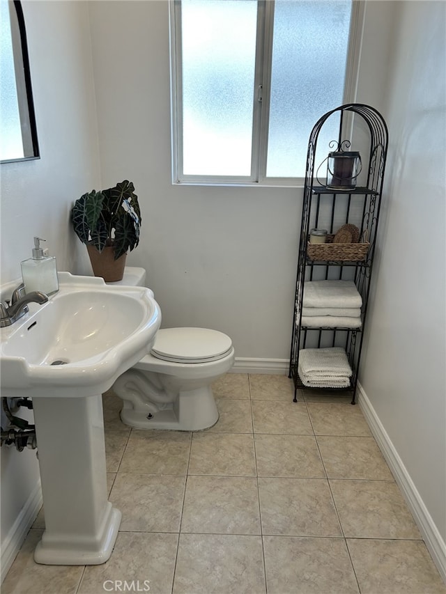 23125 Covello St, West Hills, CA 91307 - bathroom with toilet, tile patterned floors, a sink, and baseboards