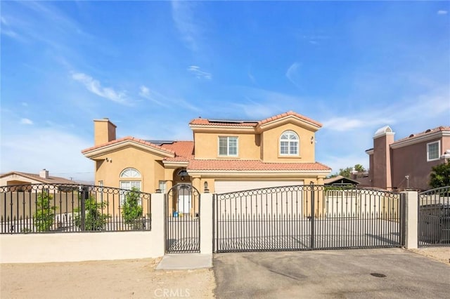 31780 Sierra Del Sol, Thousand Palms, CA 92276 - mediterranean / spanish-style house featuring a gate, asphalt driveway, stucco siding, a tile roof, and a fenced front yard