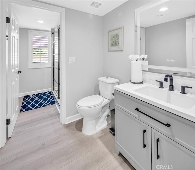 31780 Sierra Del Sol, Thousand Palms, CA 92276 - bathroom with wood finished floors, vanity, toilet, a stall shower, and baseboards
