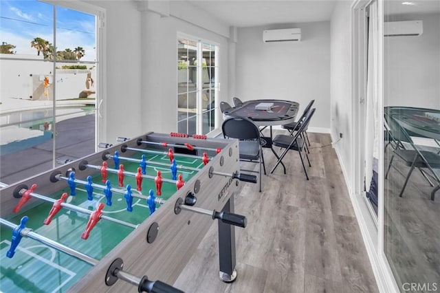 31780 Sierra Del Sol, Thousand Palms, CA 92276 - playroom with an AC wall unit, wood finished floors, and baseboards
