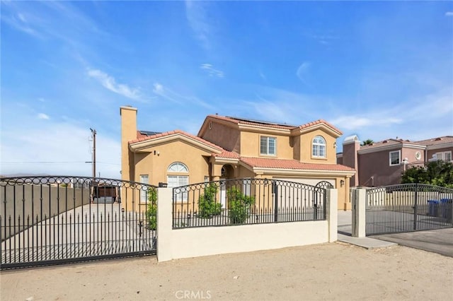 31780 Sierra Del Sol, Thousand Palms, CA 92276 - mediterranean / spanish-style house with a fenced front yard, a tile roof, stucco siding, a gate, and concrete driveway