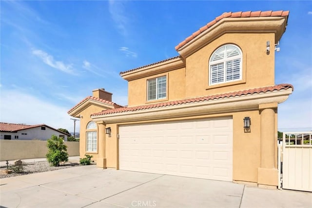 31780 Sierra Del Sol, Thousand Palms, CA 92276 - mediterranean / spanish house with a garage, driveway, stucco siding, and a tiled roof