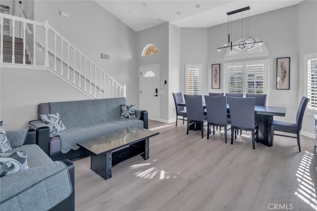 31780 Sierra Del Sol, Thousand Palms, CA 92276 - living area with stairs, a towering ceiling, baseboards, wood finished floors, and a chandelier