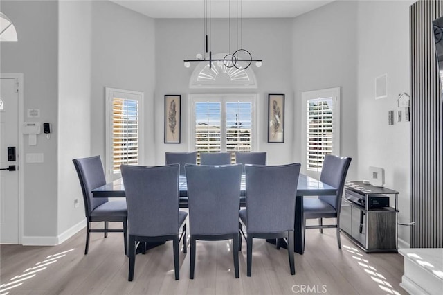 31780 Sierra Del Sol, Thousand Palms, CA 92276 - dining area featuring a chandelier, a high ceiling, wood finished floors, and baseboards