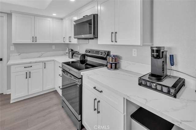 31780 Sierra Del Sol, Thousand Palms, CA 92276 - kitchen with stainless steel appliances, white cabinets, recessed lighting, light stone counters, and light wood-style flooring