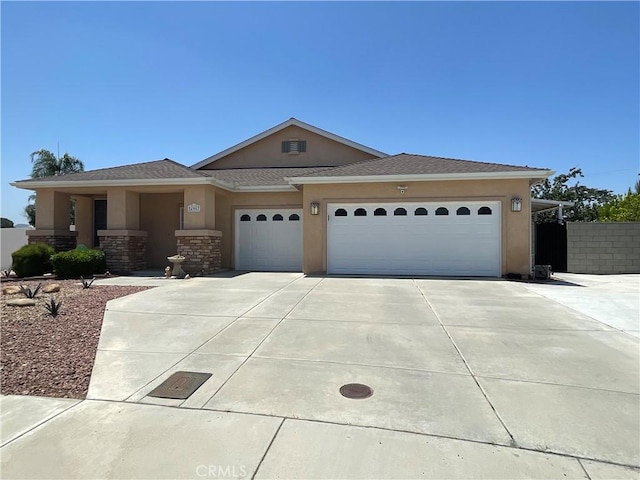24967 Volga St, Hemet, CA 92544 - view of front of property featuring an attached garage, concrete driveway, and stucco siding