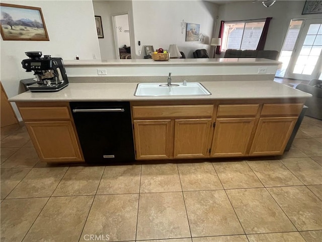 24967 Volga St, Hemet, CA 92544 - kitchen with black dishwasher, a sink, open floor plan, light countertops, and light tile patterned floors