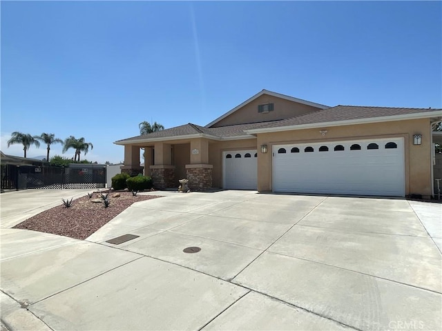 24967 Volga St, Hemet, CA 92544 - view of front of home featuring stucco siding, a garage, concrete driveway, and roof with shingles