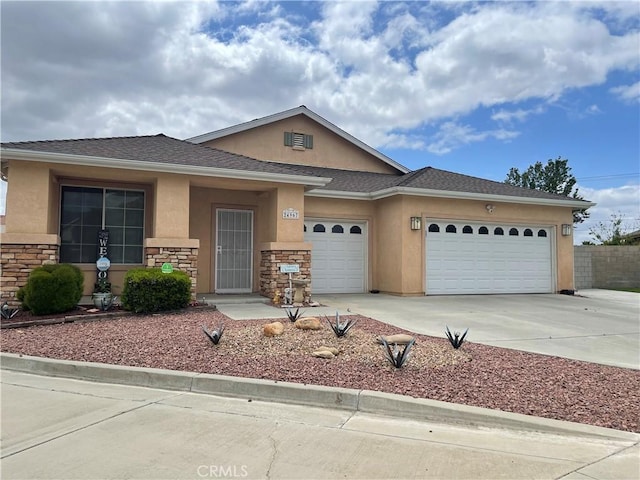 24967 Volga St, Hemet, CA 92544 - view of front of property with stucco siding, an attached garage, concrete driveway, and stone siding