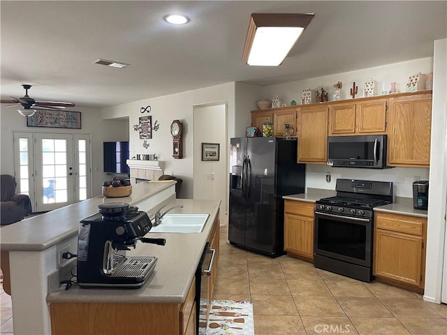 24967 Volga St, Hemet, CA 92544 - kitchen with black appliances, a sink, open floor plan, ceiling fan, and a center island with sink