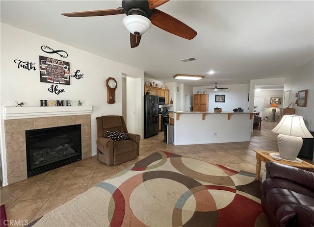 24967 Volga St, Hemet, CA 92544 - living area with a ceiling fan, light tile patterned floors, and a tile fireplace