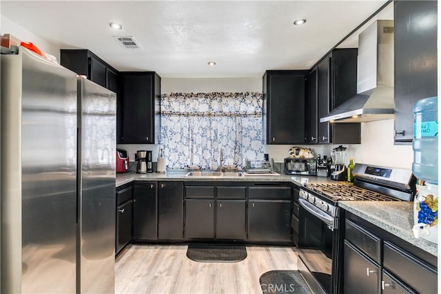 813 Yorkshire, San Jacinto, CA 92583 - kitchen featuring appliances with stainless steel finishes, wall chimney exhaust hood, a sink, and dark cabinets