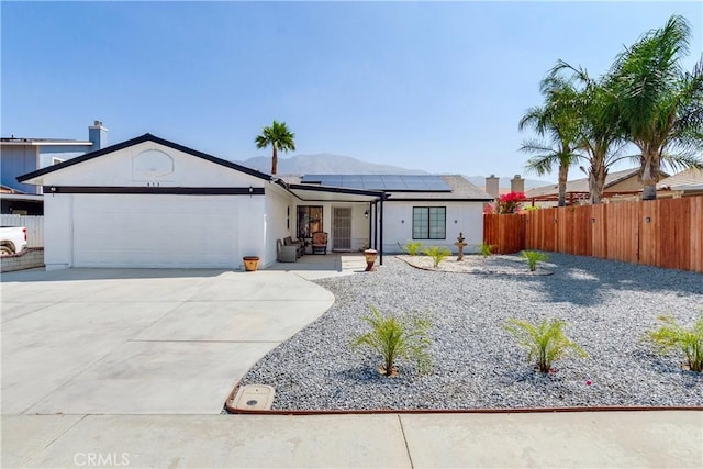 813 Yorkshire, San Jacinto, CA 92583 - ranch-style house featuring solar panels, an attached garage, concrete driveway, and stucco siding
