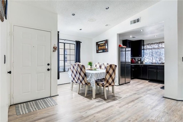 813 Yorkshire, San Jacinto, CA 92583 - dining space featuring light wood-type flooring and a textured ceiling