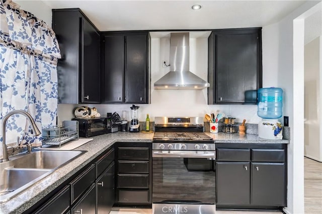813 Yorkshire, San Jacinto, CA 92583 - kitchen with wall chimney exhaust hood, stainless steel range with gas stovetop, a sink, and dark cabinets