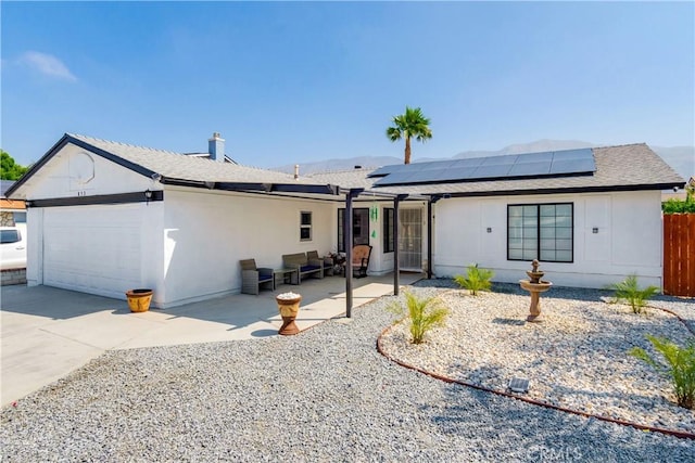 813 Yorkshire, San Jacinto, CA 92583 - view of front of house featuring a garage, solar panels, concrete driveway, a shingled roof, and a patio area