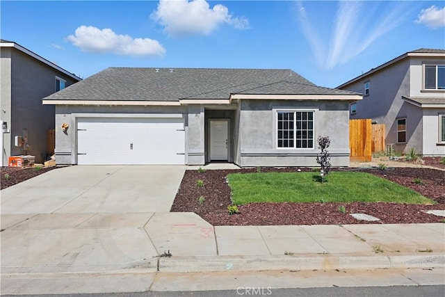 428 Oleander Ct, Chowchilla, CA 93610 - view of front of home featuring an attached garage, stucco siding, driveway, and roof with shingles
