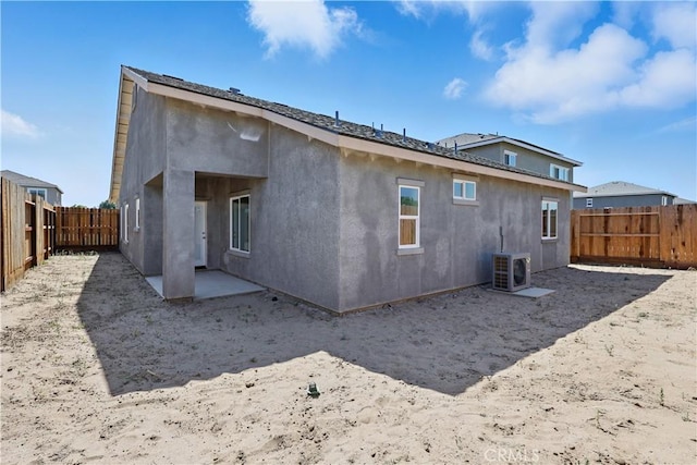 428 Oleander Ct, Chowchilla, CA 93610 - back of property with a fenced backyard, stucco siding, a cooling unit, and a patio area