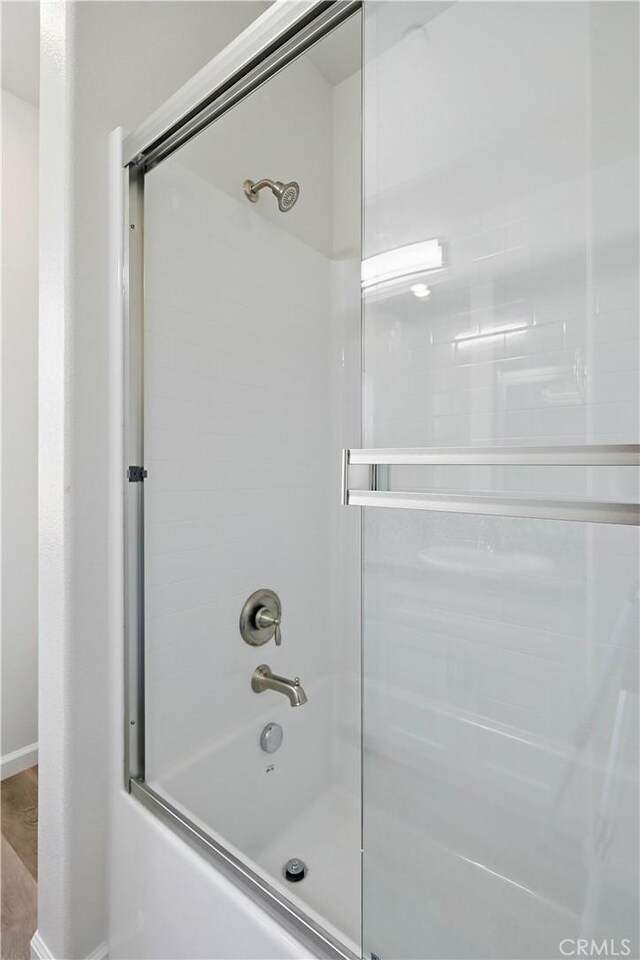 428 Oleander Ct, Chowchilla, CA 93610 - full bathroom featuring bath / shower combo with glass door and baseboards