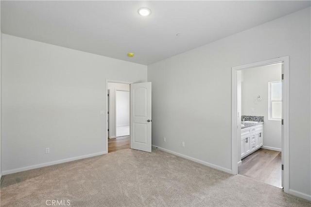 428 Oleander Ct, Chowchilla, CA 93610 - unfurnished bedroom with light carpet, baseboards, and connected bathroom