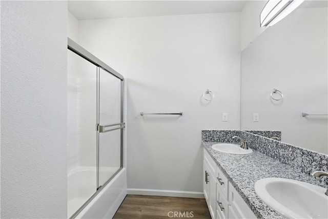 428 Oleander Ct, Chowchilla, CA 93610 - full bath with wood finished floors, double vanity, enclosed tub / shower combo, and baseboards